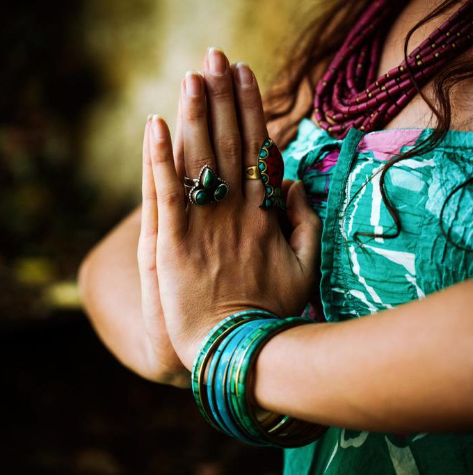 Woman with hands together in meditation